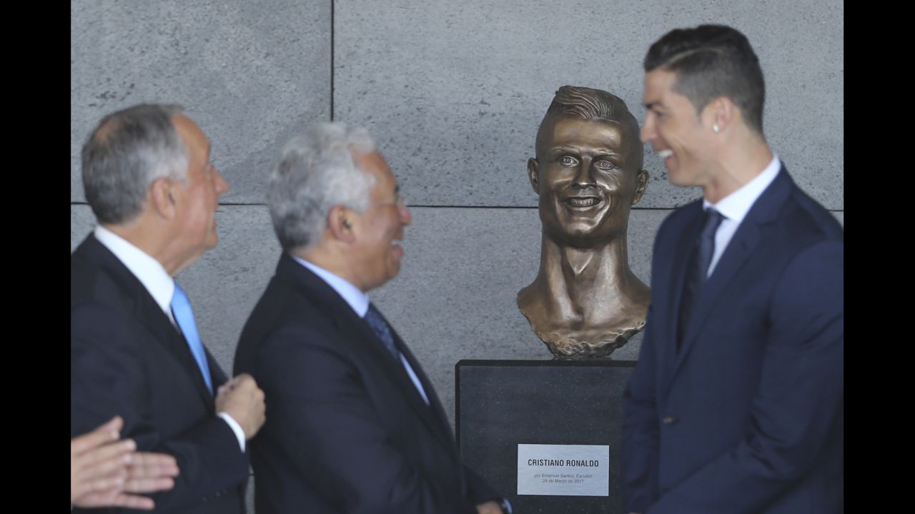 Soccer star Cristiano Ronaldo, right, is joined by Portuguese President Marcelo Rebelo de Sousa, left, and Prime Minister Antonio Costa after the Madeira Airport <a href="http://www.cnn.com/2017/03/29/football/cristiano-ronaldo-airport-madeira-bust-statue-unveiling/" target="_blank">was renamed in his honor</a> on Wednesday, March 29. The bronze bust of Ronaldo stole many of the headlines, especially on social media.