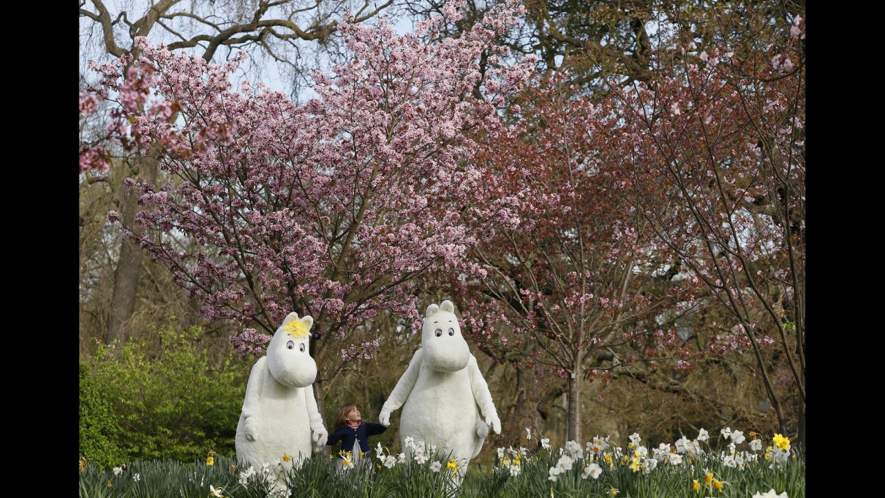 Sofia Lopez, 3, meets fictional characters Moominmamma, left, and Moomintroll at an Easter festival in London on Thursday, March 30. The Moomins are fairy-tale characters created by Finnish illustrator and writer Tove Jansson.
