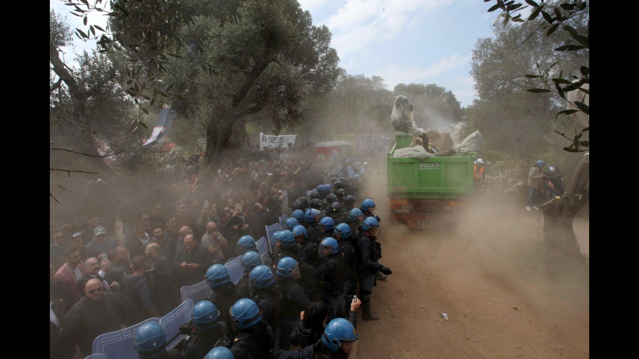 Protesters in Melendugno, Italy, clash with police near the site of a gas pipeline project on Tuesday, March 28. The protesters were opposing the removal of olive trees near the construction of the Trans Adriatic Pipeline.