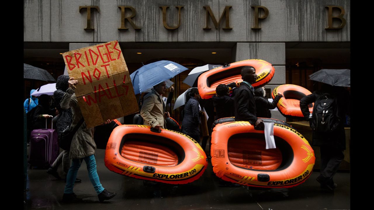 People carry inflatable rafts in front of New York's Trump Tower as they protest President Donald Trump's refugee policies on Tuesday, March 28.