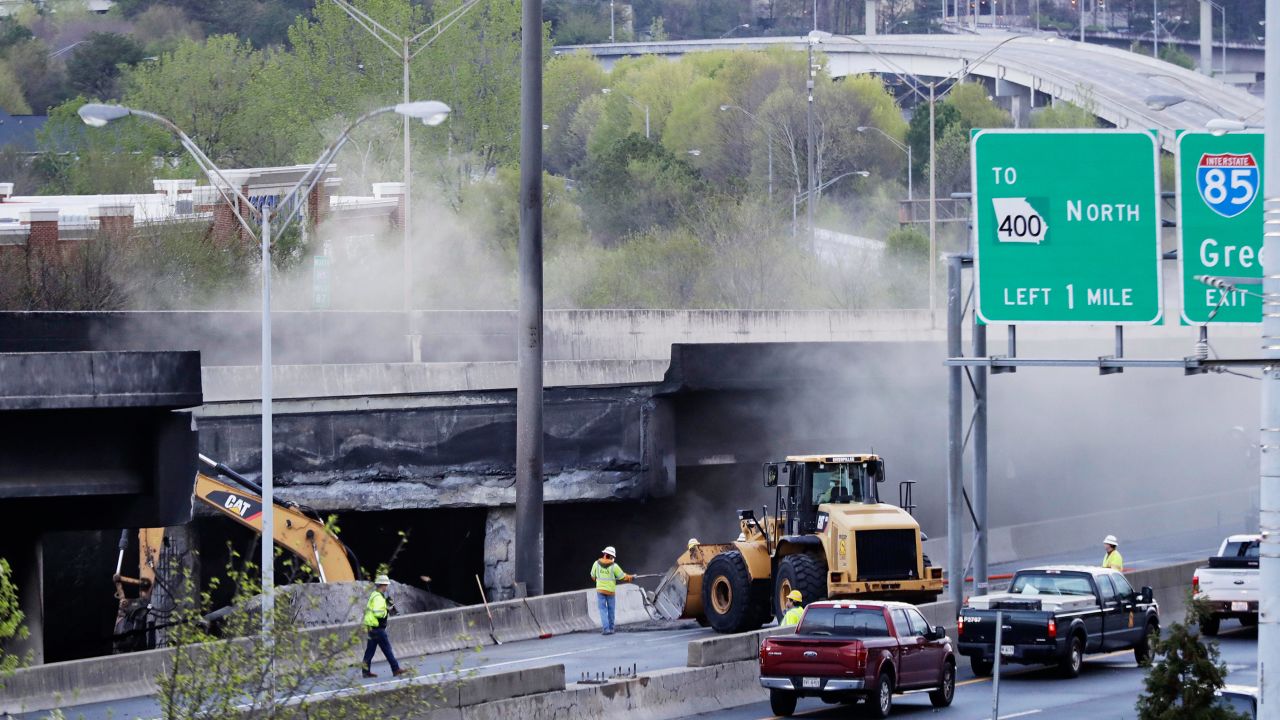 Crews work Friday on a section of I-85 that collapsed during a masive fire.