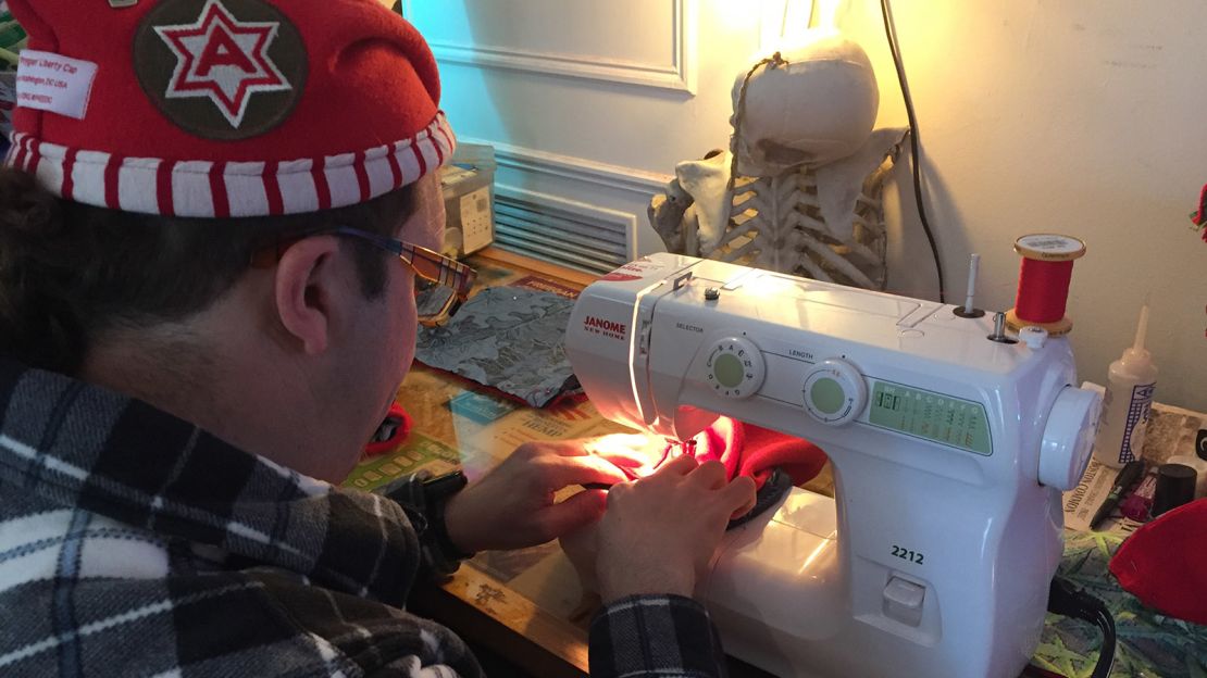 DCMJ co-founder Adam Eidinger sews together the group's signature "Phrygian cap," also known as the "liberty cap."