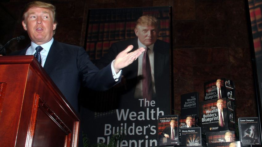 Real estate mogul Donald Trump gestures as he holds a media conference announcing the establishment of Trump University May 23, 2005 in New York City. Trump University will consist of on-line courses, CD-Roms and other learning programs for business professionals.