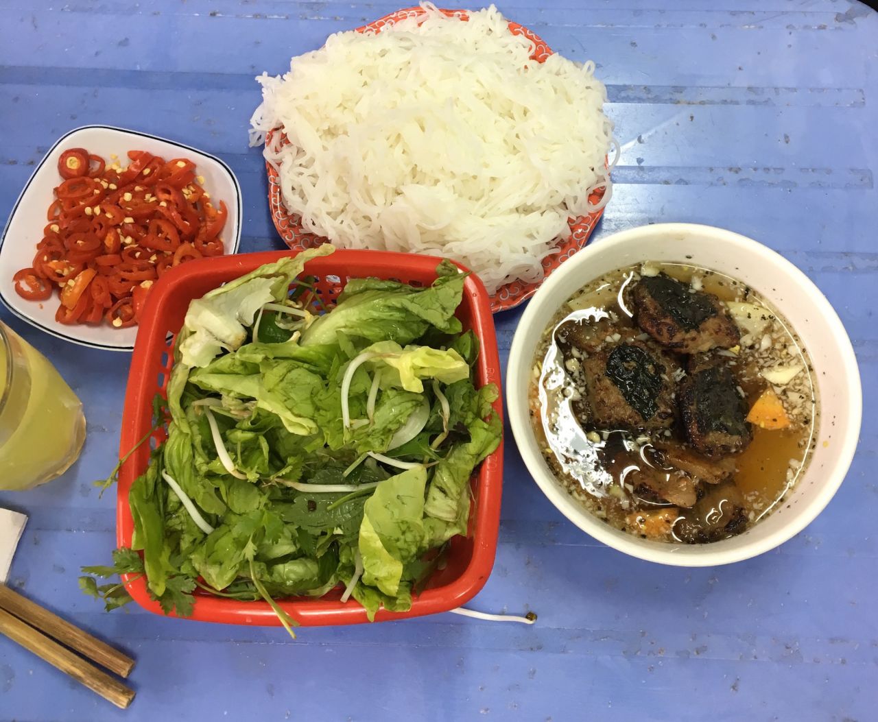 A cold noodle dish, bún chả  features hunks of charcoal-grilled fatty pork. 
