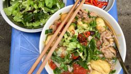 The first thing you'll notice about Bún riêu -- a meat or seafood vermicelli soup -- is its deep red color. The soup gets its hue from tomato paste and annatto seed -- from achiote tree seeds. The flavor is just as enticing, featuring chunks of crabmeat, fried tofu, tamarind paste, and light vermicelli noodles. 
