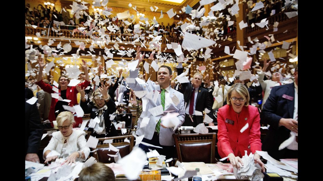 Georgia lawmakers throw paper into the air at the conclusion of the legislative session in Atlanta on Friday, March 31.