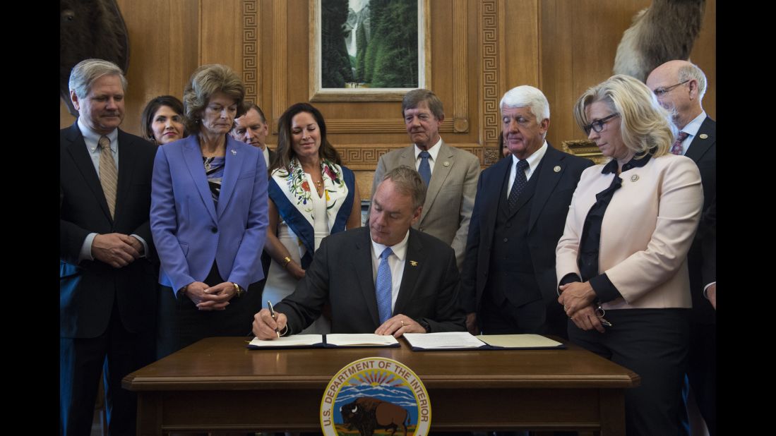 Interior Secretary Ryan Zinke, accompanied by Republican members of Congress, signs an order Wednesday, March 29, that lifts a moratorium on new coal leases on federal lands.