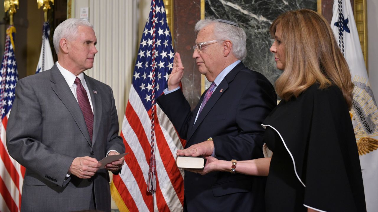 US Vice President Mike Pence, left, swears in David Friedman as the US ambassador to Israel on Wednesday, March 29. Friedman's wife, Tammy Sand, looks on.
