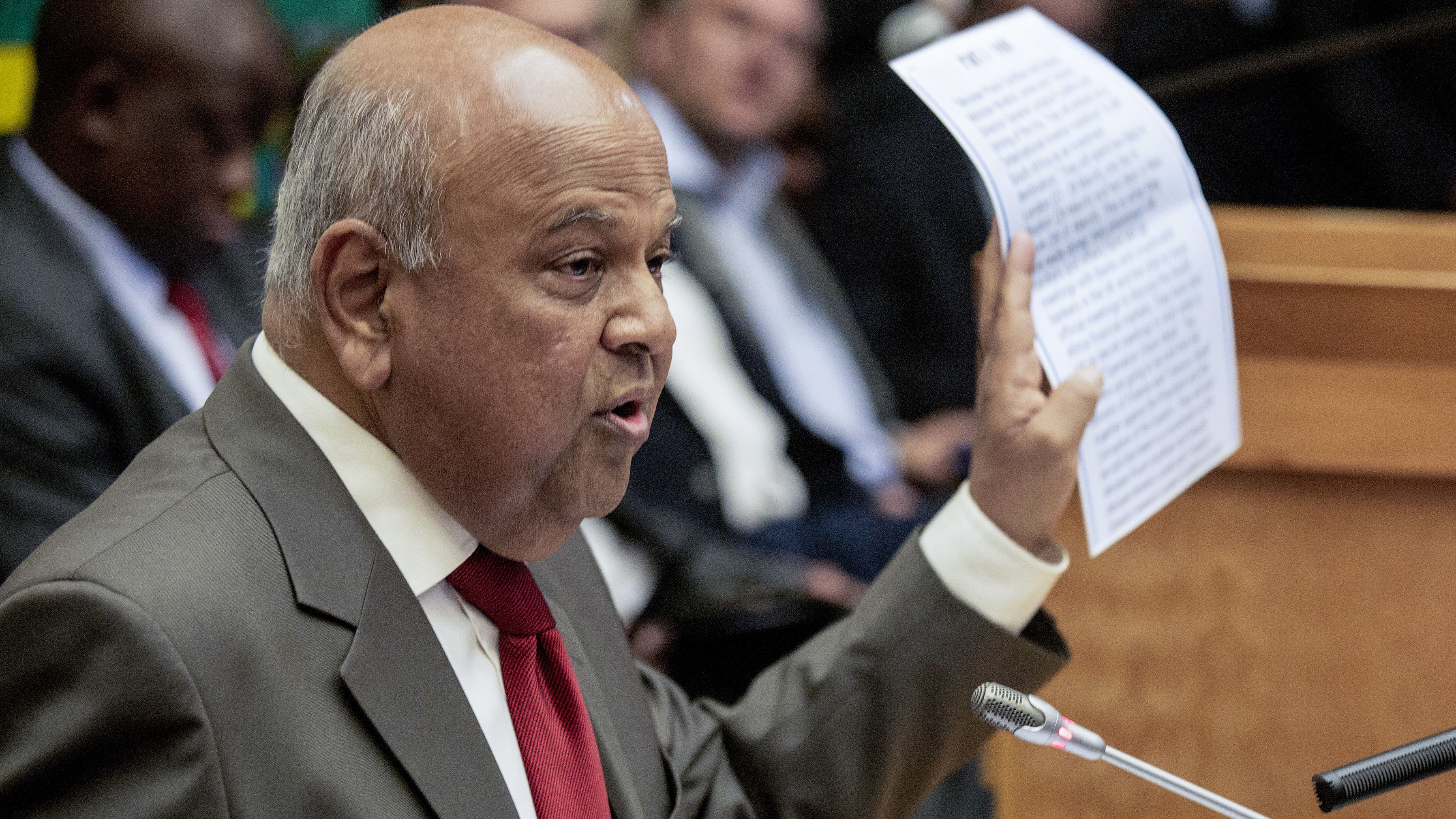 Pravin Gordhan holds an alleged intelligence report during a press conference Friday. 