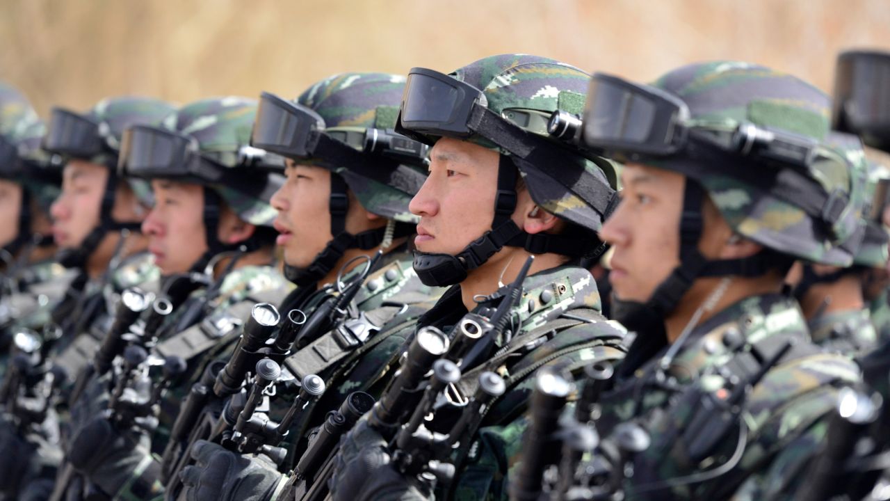 Chinese military police attend an anti-terrorist oath-taking rally in Xinjiang. 