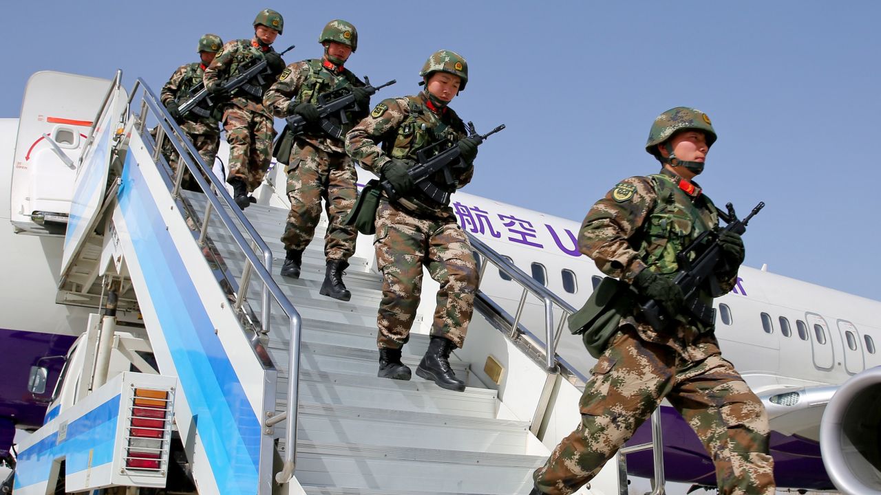 Photo taken on February 27, 2017 shows Chinese military police getting off a plane to attend an anti-terrorist oath-taking rally in Hetian, Xinjiang.