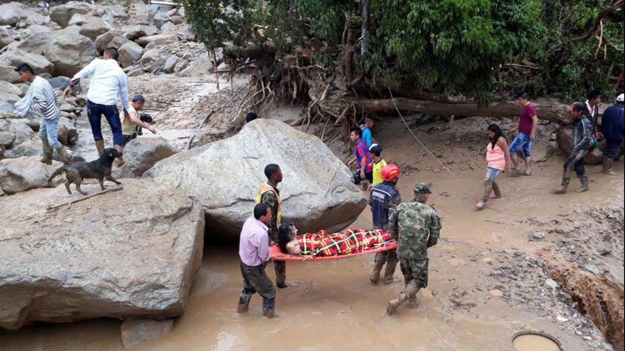 Volunteers and soldiers carry one of the injured in Mocoa.