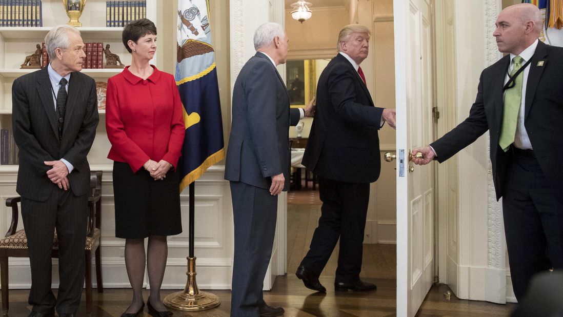 Vice President Mike Pence, third from left, tries to stop President Donald Trump <a href="http://www.cnn.com/2017/03/31/politics/donald-trump-executive-order-signing-walk-out/index.html" target="_blank">as Trump walks out of an executive order signing ceremony</a> on Friday, March 31. During the signing ceremony, White House pool reporters asked Trump questions about former national security adviser Michael Flynn, who has offered to testify on Russian involvement in the US election. The President ignored the questions and moved to another room to sign the two executive orders, which regarded trade policy.