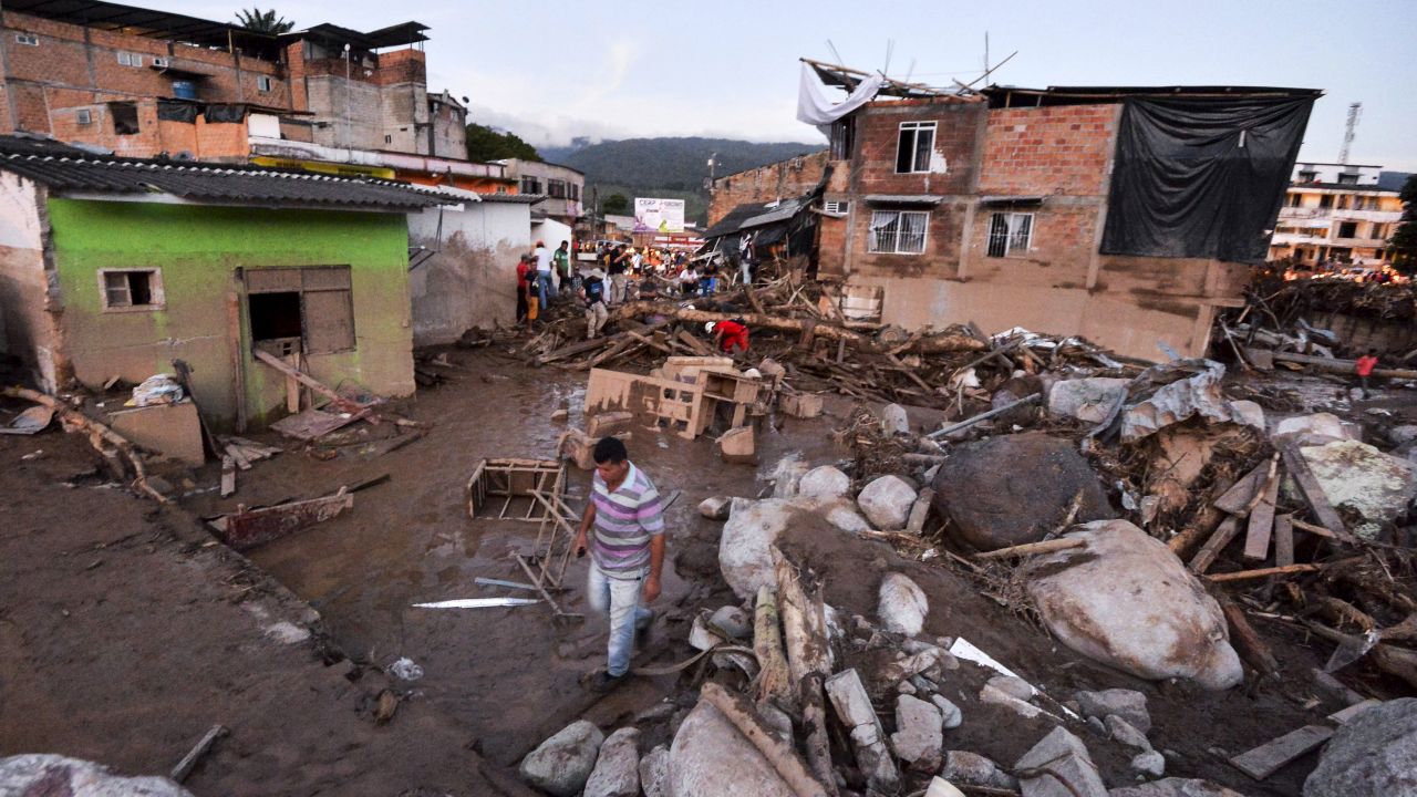 Many people searched through the debris for their possessions after the mudslide destroyed their homes.