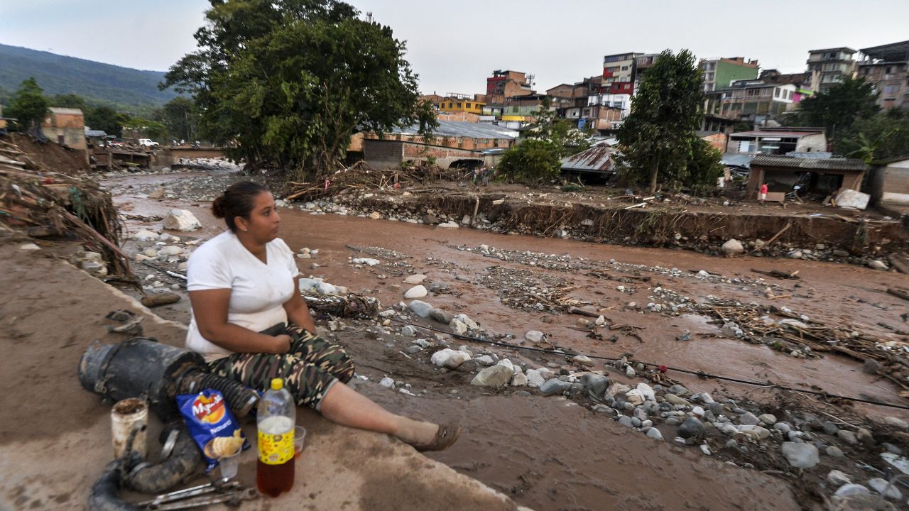 A woman surveys some of the damage in Mocoa. 