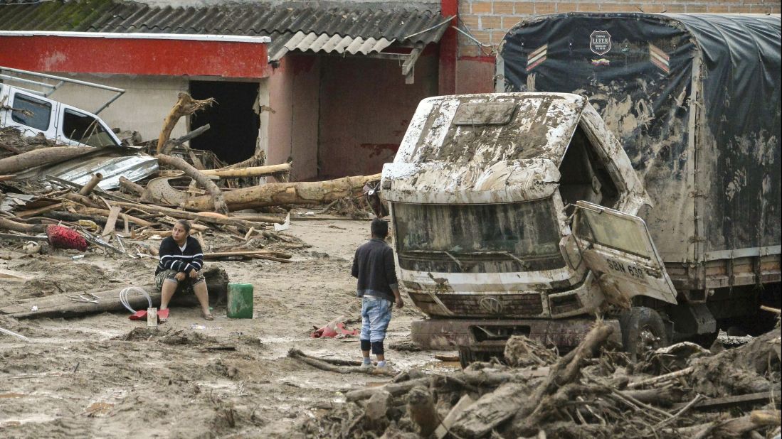 The day after a mudslide hit Mocoa, people walk among the devastation on  April 2.