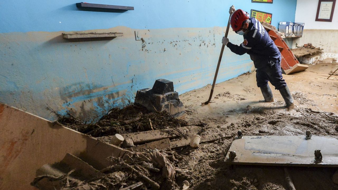 A firefighter searches for victims inside a house in Mocoa.