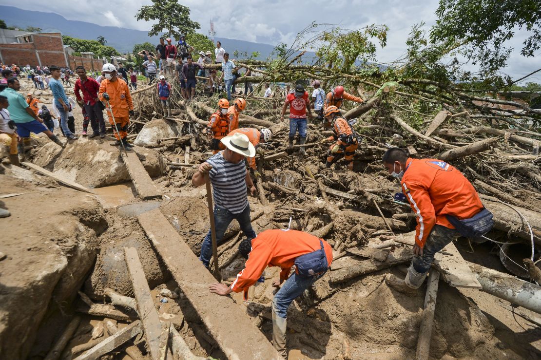 On April 2, rescuers search for victims trapped under debris left by mudslides in Mocoa, Colombia.