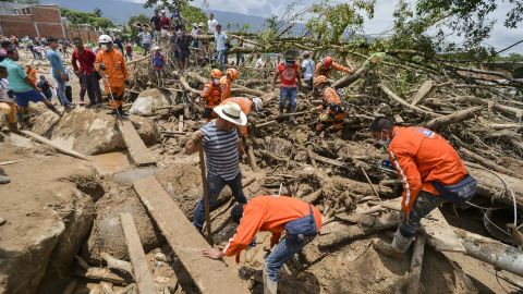 On April 2, rescuers search for victims trapped under debris left by mudslides in Mocoa, Colombia.