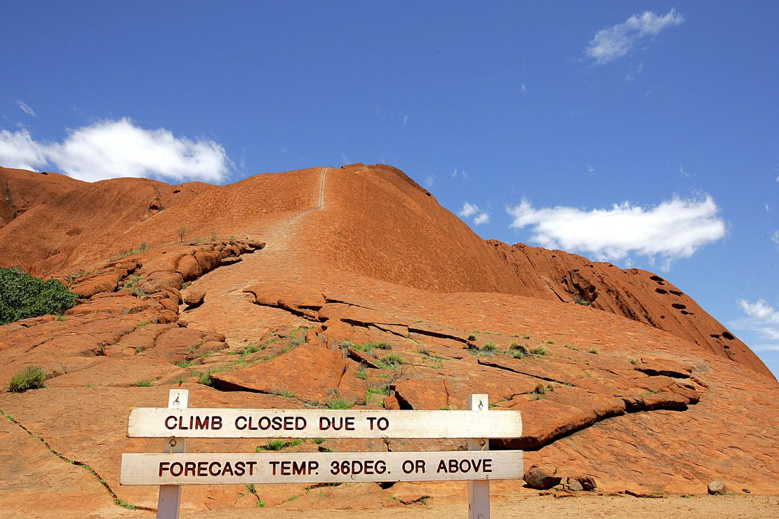 A sign declares the climb to Uluru "closed" in 2005 as desert temperatures soar and high winds make the trek too dangerous.