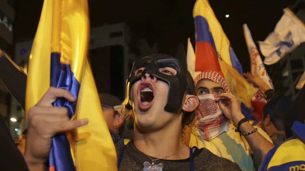 Supporters of presidential candidate Guillermo Lasso protest near the National Electoral Council in Quito, Ecuador, Sunday, April 2, 2017.