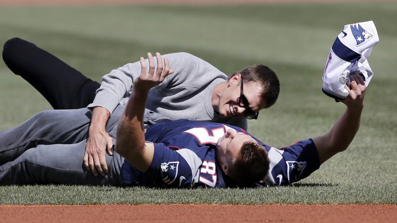 New England Patriots quarterback Tom Brady tackles teammate Rob Gronkowski during the Opening Day ceremonies of the Boston Red Sox on Monday, April 3. Gronkowski had playfully run off with Brady's recent Super Bowl jersey, which had been stolen and <a href="index.php?page=&url=http%3A%2F%2Fwww.cnn.com%2F2017%2F03%2F20%2Fsport%2Ftom-brady-stolen-super-bowl-jerseys-recovered%2F" target="_blank">later recovered in Mexico.</a>