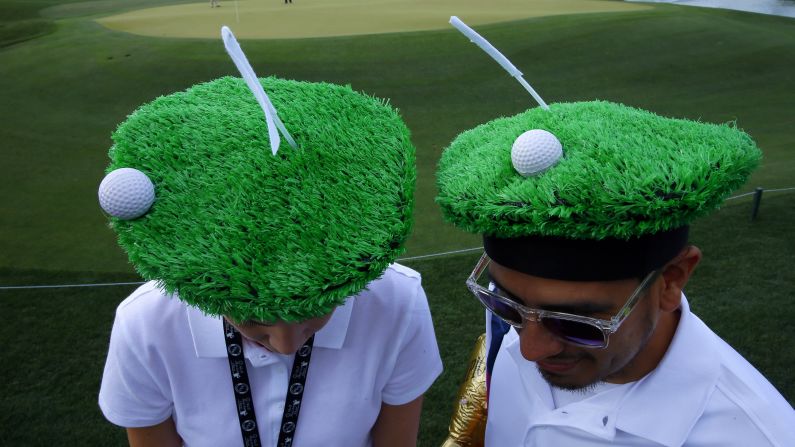 Employees of the Houston Golf Association hang around the 18th green during the Shell Houston Open on Thursday, March 30.