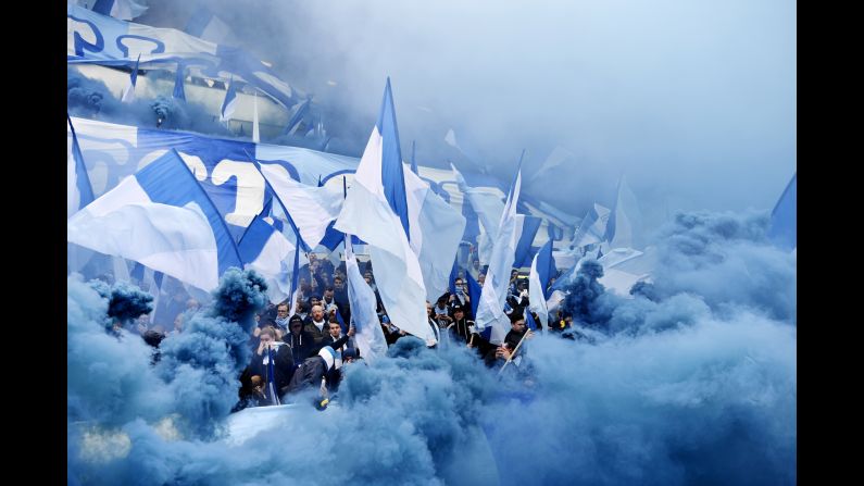 Malmo fans are surrounded by blue smoke during a Swedish league match in Gothenburg on Saturday, April 1.