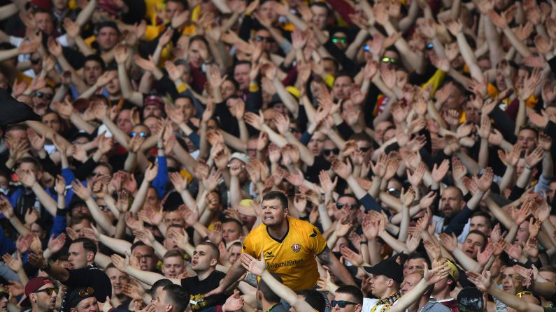Fans of the soccer club Dynamo Dresden show their support during a German league match in Stuttgart on Sunday, April 2.
