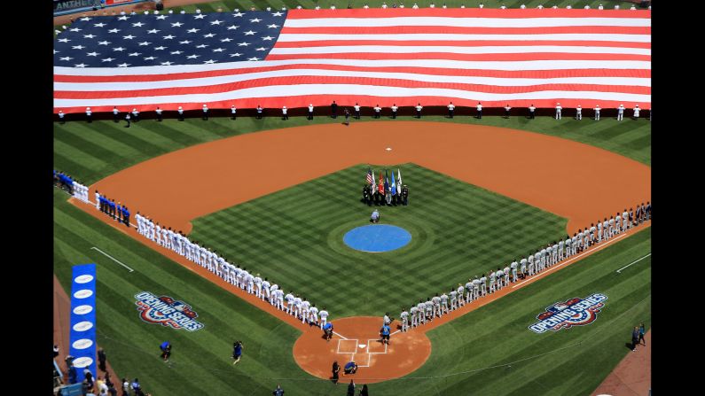 Teams line up for the national anthem before the Opening Day game in Los Angeles on Monday, April 3.