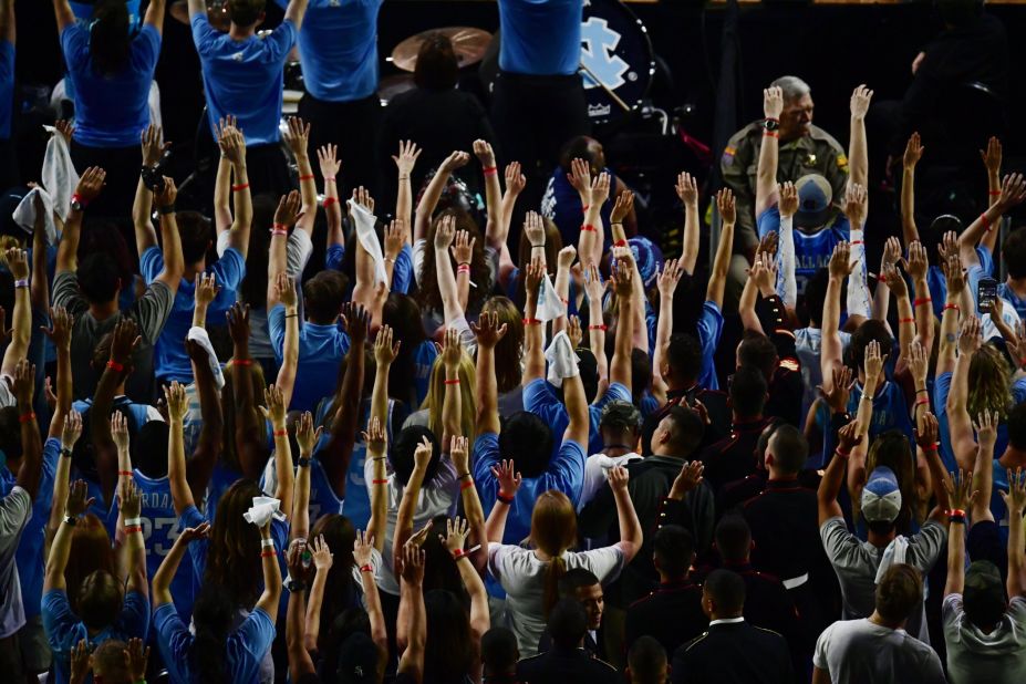 North Carolina fans hold up their hands.
