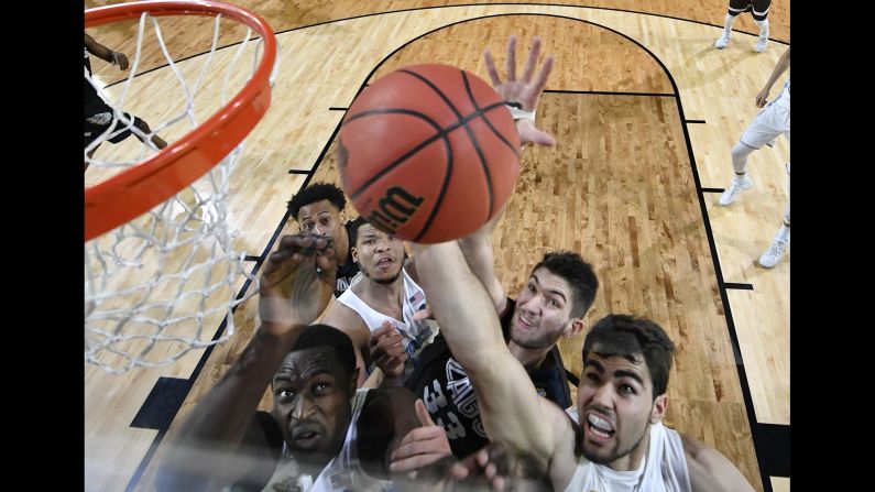 Players battle for a rebound during the second half.