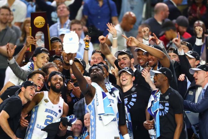 North Carolina players take a selfie together after being handed the trophy.