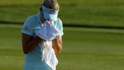 Lexi Thompson cries in a towel as she walks to the 18th green after her second shot during the final round of the ANA Inspiration 