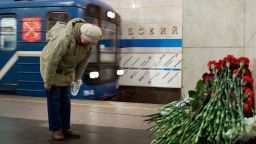 A woman pays her respects at a symbolic memorial at Tekhnologichesky Institute subway station in St. Petersburg, Russia, Tuesday, April 4, 2017. A bomb blast tore through a subway train deep under Russia's second-largest city St. Petersburg Monday, killing several people and wounding many more in a chaotic scene that left victims sprawled on a smoky platform.  (AP Photo/Dmitri Lovetsky)