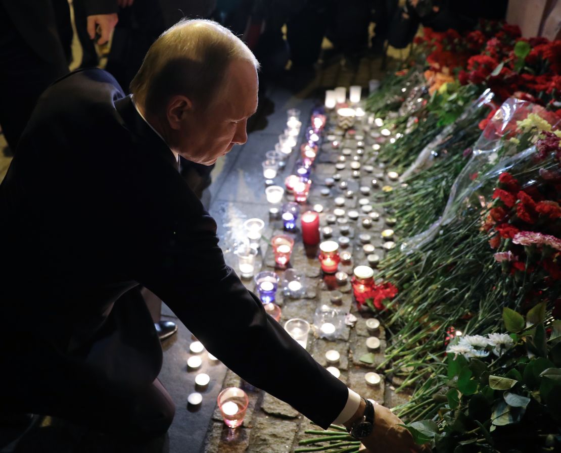 Russian President Vladimir Putin places flowers in memory of victims at the Technological Institute metro station in St. Petersburg.