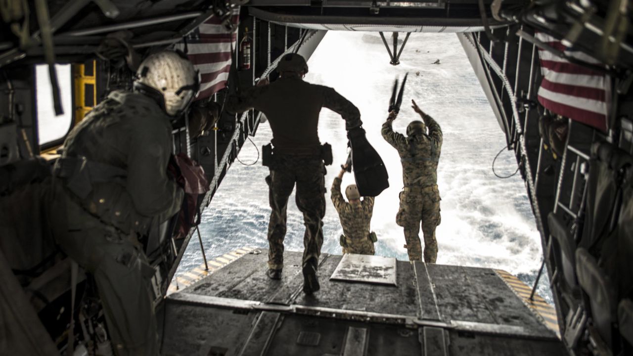 US Marines jump out of a helicopter during an exercise in the Philippine Sea on Sunday, March 19.