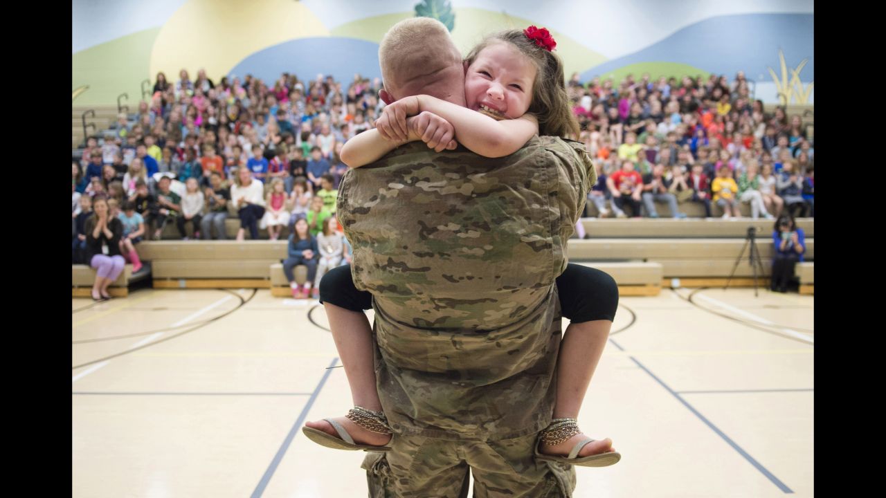 Second-grader Imogen Nowak cries in the arms of her father, US Army Capt. Erik Nowak, after he surprised her at a school assembly in Sewickley, Pennsylvania, on Tuesday, March 28. He had been deployed since September.