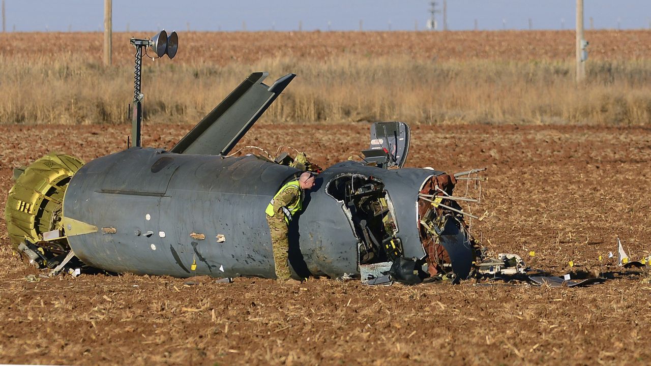 Air Force personnel inspect wreckage Wednesday, March 15, after a surveillance aircraft crashed outside of Clovis, New Mexico. Three airmen were killed in the crash, which is being investigated.
