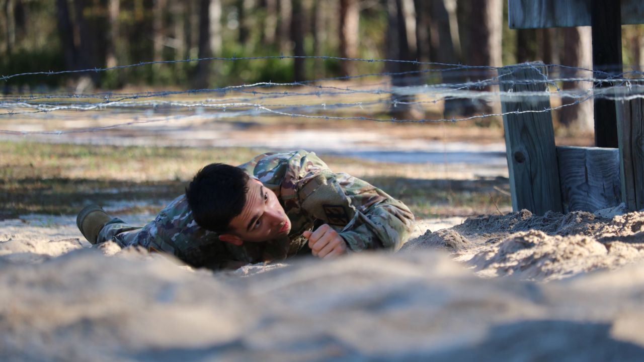 Spc. Mason Mackrell of the Georgia Army National Guard crawls under barbed wire during an obstacle course competition in Fort Stewart, Georgia, on Friday, March 10.