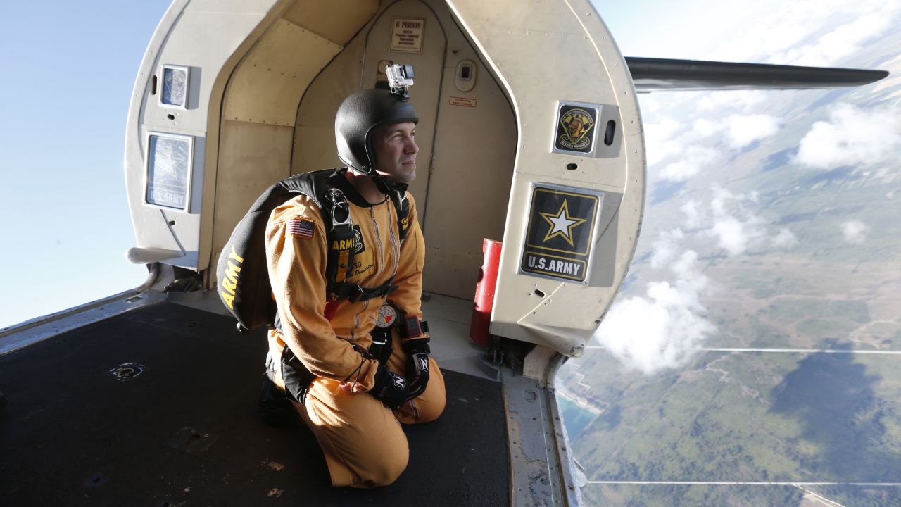 Staff Sgt. Marcus Denniston, a member of the US Army's "Golden Knights" Parachute Team, prepares for a training jump Wednesday, March 8, in Homestead, Florida.