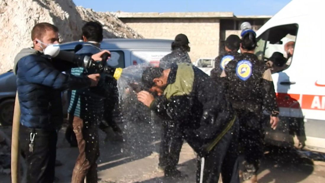 Civil defense workers try to reduce the effects of toxic gas as they carry out search-and-rescue missions in Khan Sheikhoun.