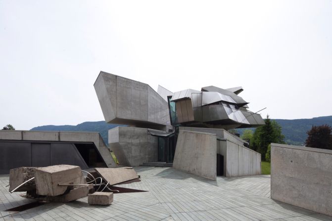 Located in the mountains of Carinthia, Austria, the house, with sharp angular lines and dark panels, represented the late architect's personality. 