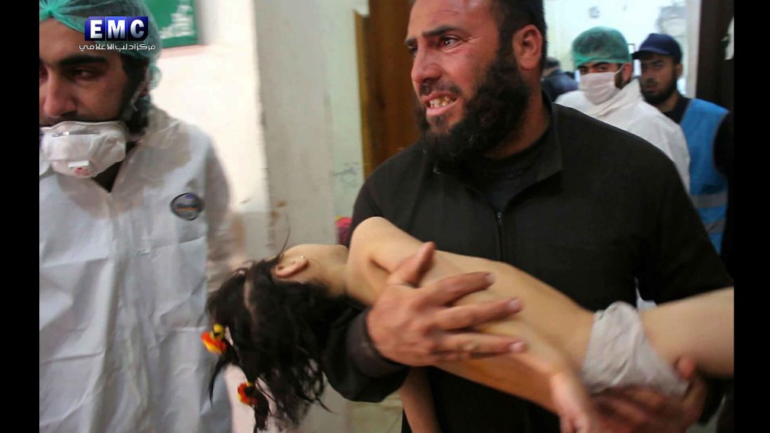 A man carries a child at a makeshift hospital in Khan Sheikhoun. Activists have blamed the Syrian regime for the attack. In an apparent reference to the attack, two state-run Syrian media outlets reported that there was an explosion at a "rebel poison gas factory" in the countryside of Idlib province. The government has denied using chemical weapons in the past.