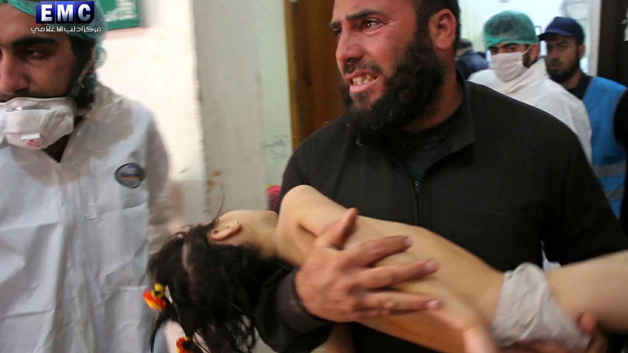 This photo provided on Tuesday April 4, 2017, by the Syrian anti-government activist group Edlib Media Center, that is consistent with independent AP reporting, shows a man carrying a child following a suspected chemical attack, at a makeshift hospital in the town of Khan Sheikhoun, northern Idlib province, Syria. The suspected chemical attack killed dozens of people on Tuesday, Syrian opposition activists said, describing the attack as among the worst in the country's six-year civil war. (Edlib Media Center, via AP)