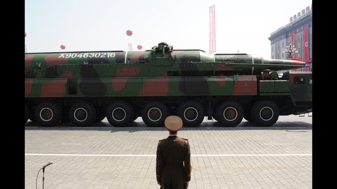 A North Korean soldier stands guard in front of a military vehicle carrying what is believed to be a Taepodong-class missile during a military parade to mark the 100th birthday of the country's founder Kim Il Sung in Pyongyang on April 15, 2012.