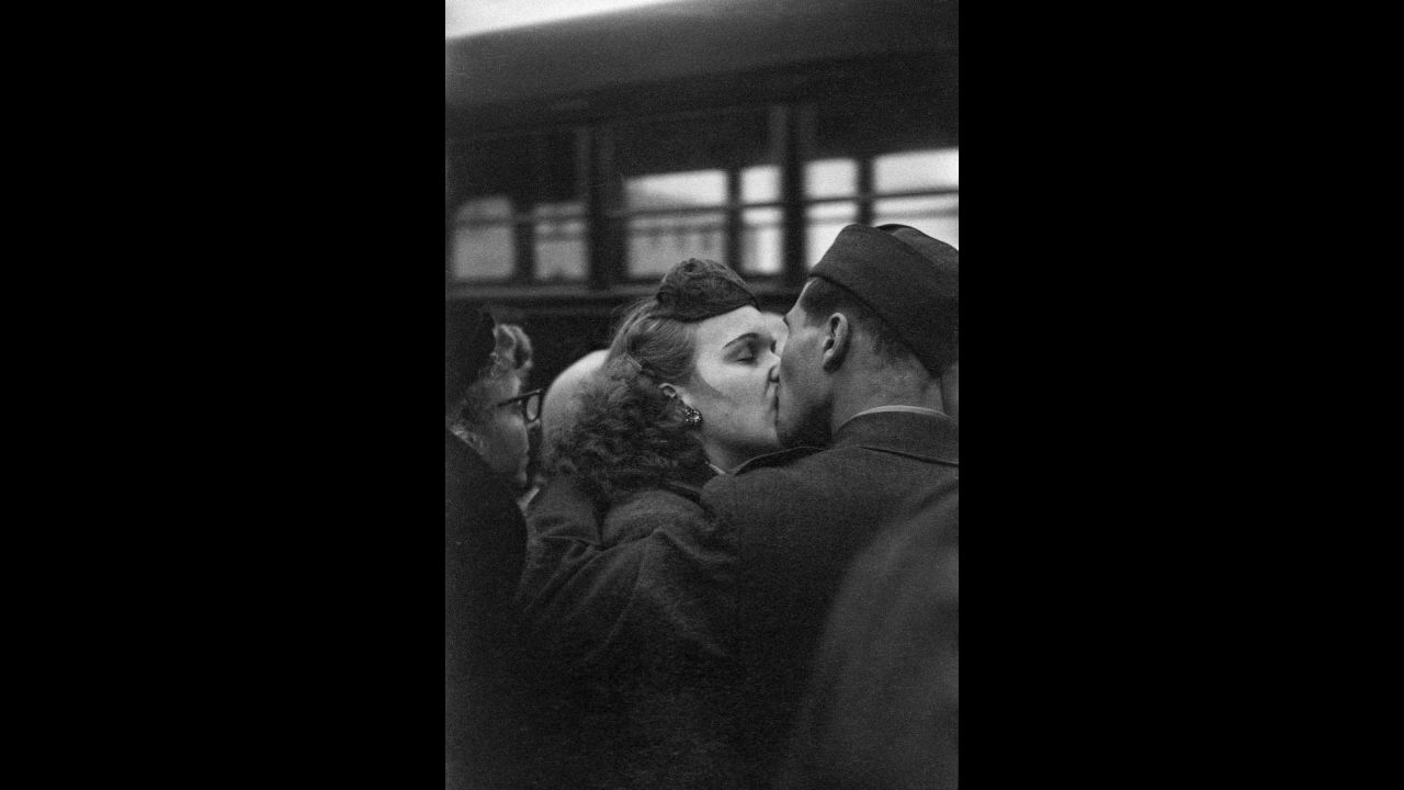 A couple kisses goodbye as a soldier prepares for deployment in 1952. At the time, the United States was involved in the Korean War.