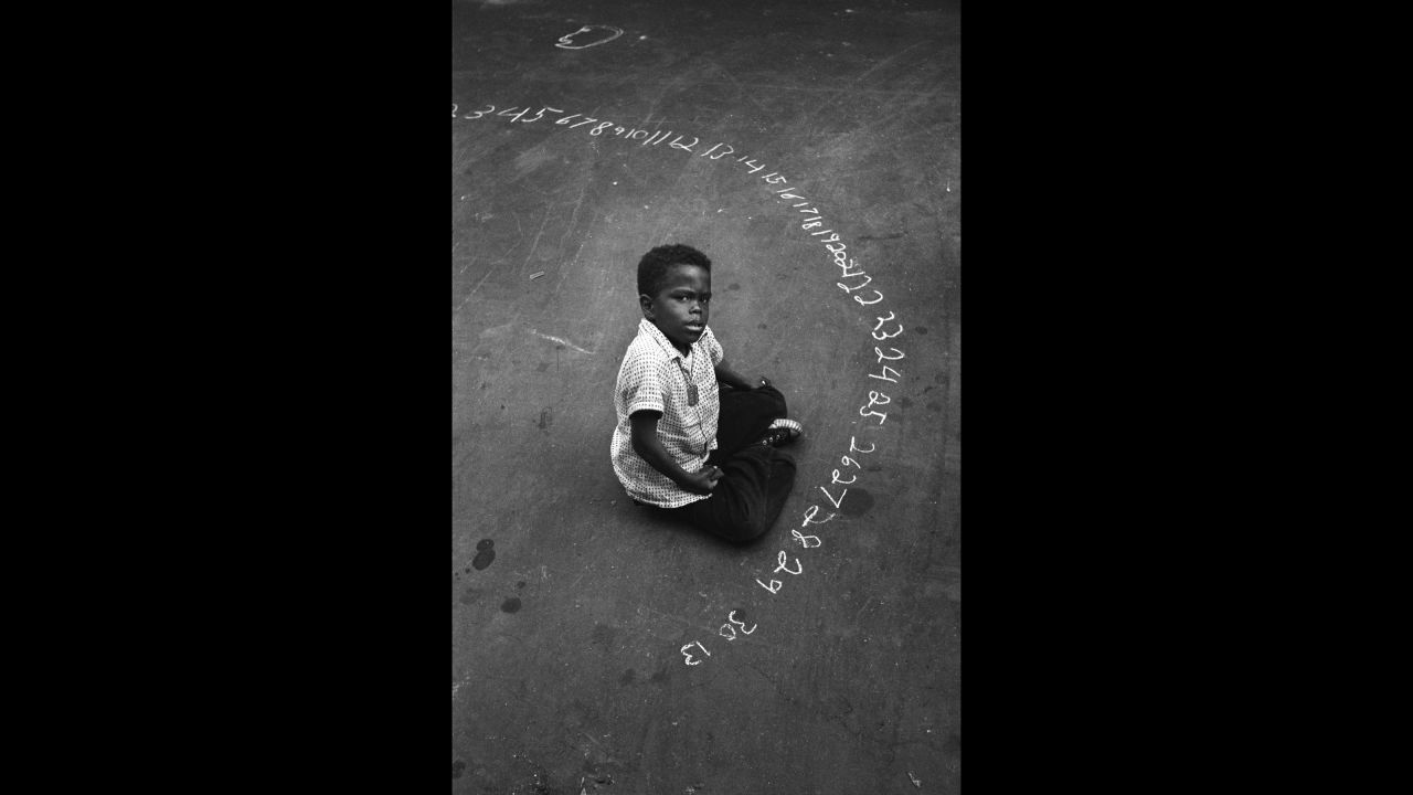 A boy uses chalk to write numbers on a New York street in 1955. After Feinstein's death in 2015, <a href="https://www.nytimes.com/2015/06/30/arts/harold-feinstein-dies-at-84-froze-new-york-moments-in-black-and-white.html" target="_blank" target="_blank">The New York Times</a> called the photographer "one of the most accomplished recorders of the American experience."