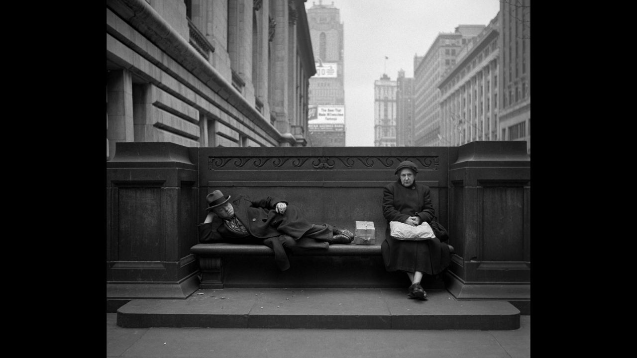 A man and woman share a bench outside the New York Public Library in 1949. "When you see (Feinstein's) pictures, you think: 'Wow, what a beautiful world. What a beautiful America,' " Bigaignon said. "It's like a long-gone America."