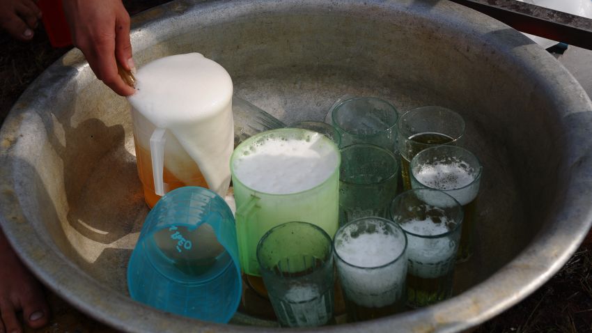 Glasses and jugs are filled of "Hanoi bia hoi"at the Hanoi Beer festival held in downtown Hanoi on December 4, 2011. With a 1 USD entrance ticket people can drink free "bia hoi Hanoi", a very popular local streetside draught beer. The event attracted thousands of beer drinkers. AFP PHOTO /HOANG DINH Nam (Photo credit should read HOANG DINH NAM/AFP/Getty Images)